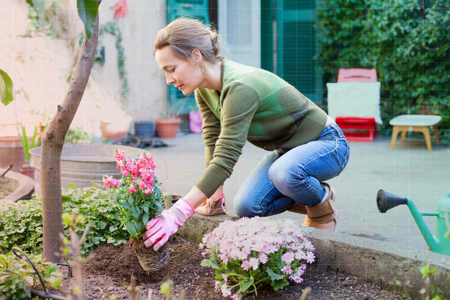 Woman planting flowers in her backyard