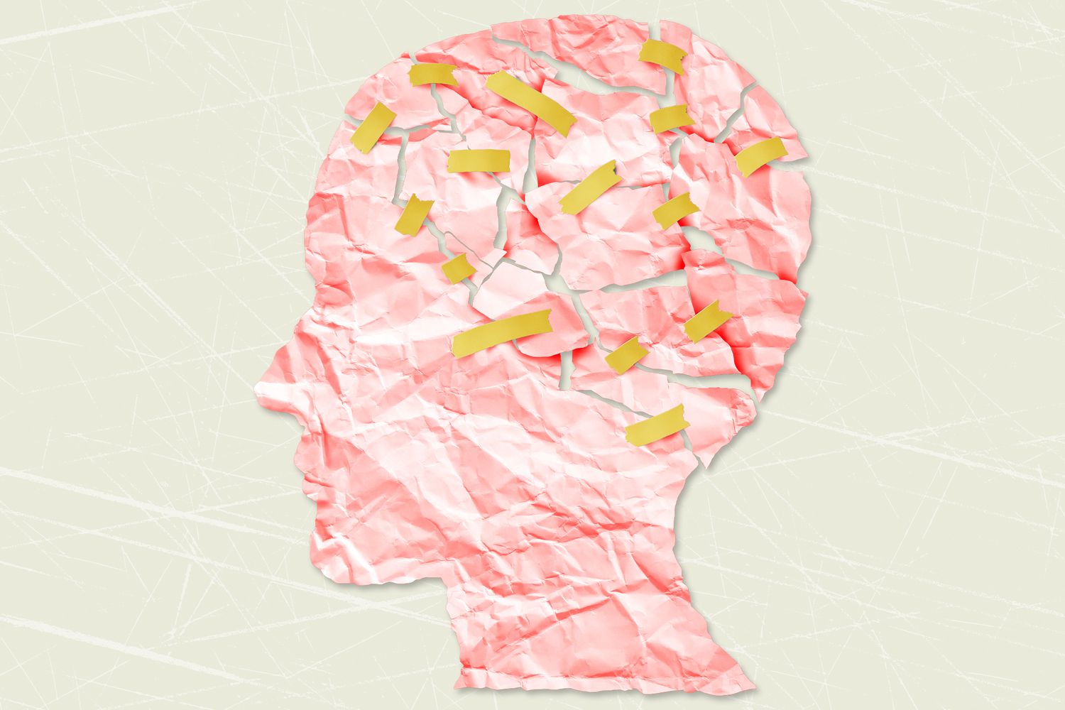 A paper cut of of a head that has been torn and taped back together on a designed background