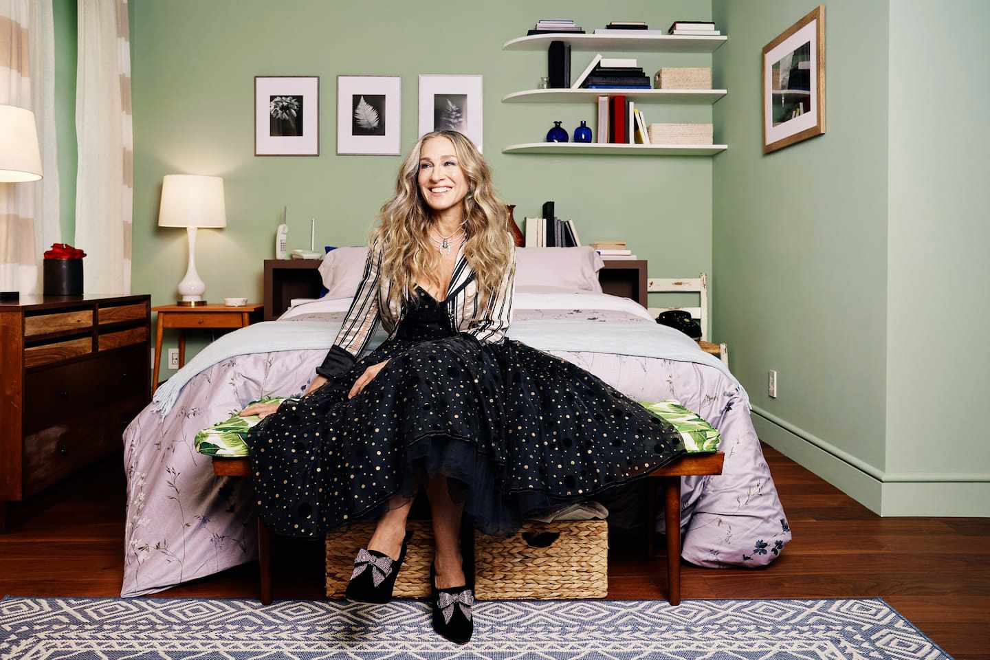 Sarah Jessica Parker sitting in an apartment bedroom