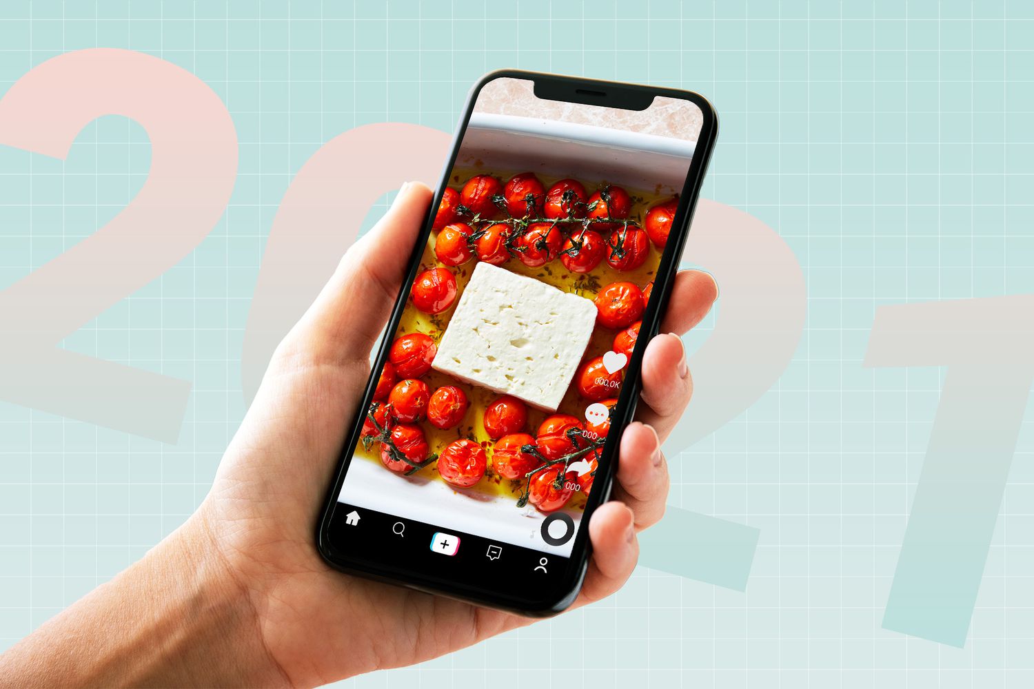 a hand holding a phone showing a block of feta surrounded by tomatoes on the screen