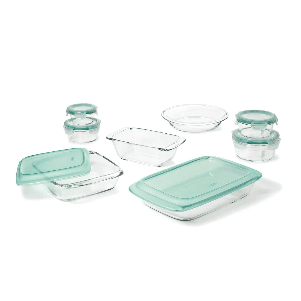 7 glass containers and 7 green lids on white background