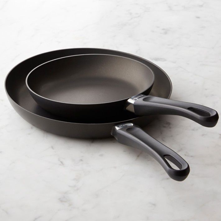 large and small black skillets on countertop