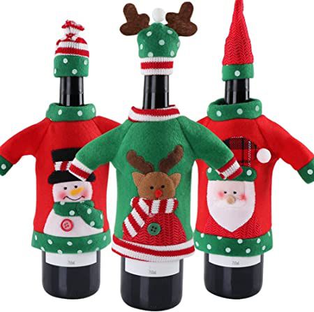 three wine bottles wearing small red and green sweaters and tiny hats