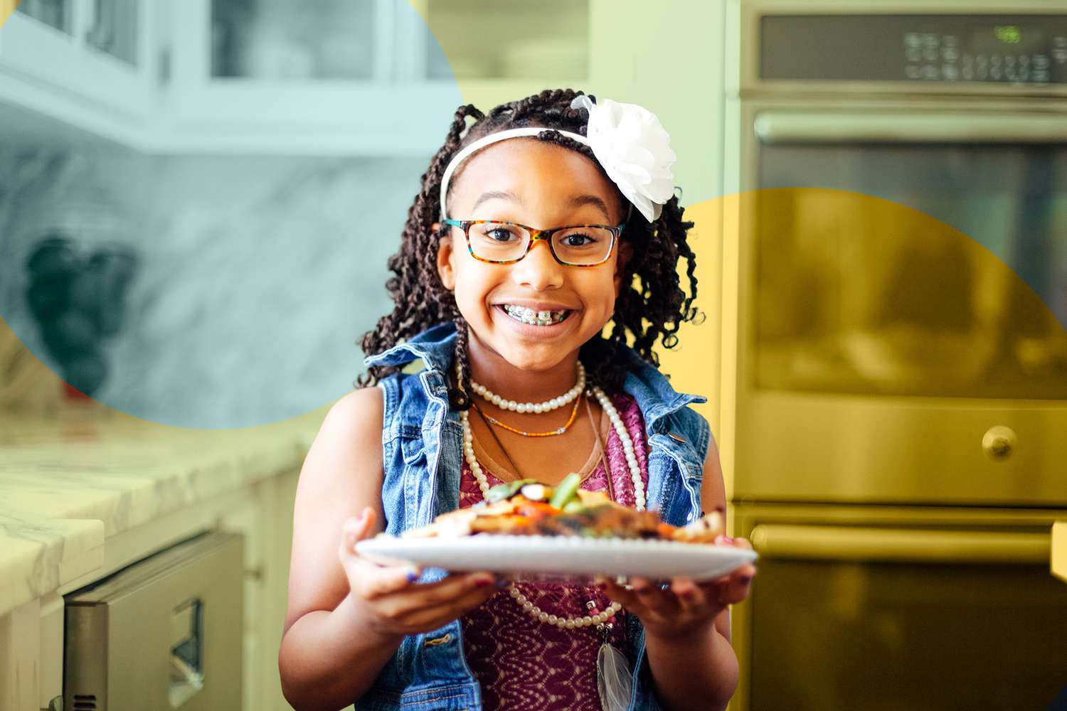 Portrait of cheerful girl with food plate in kitchen