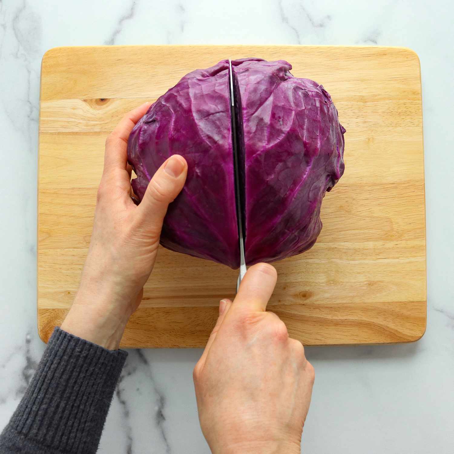 A close up of a head of cabbage being cut in half