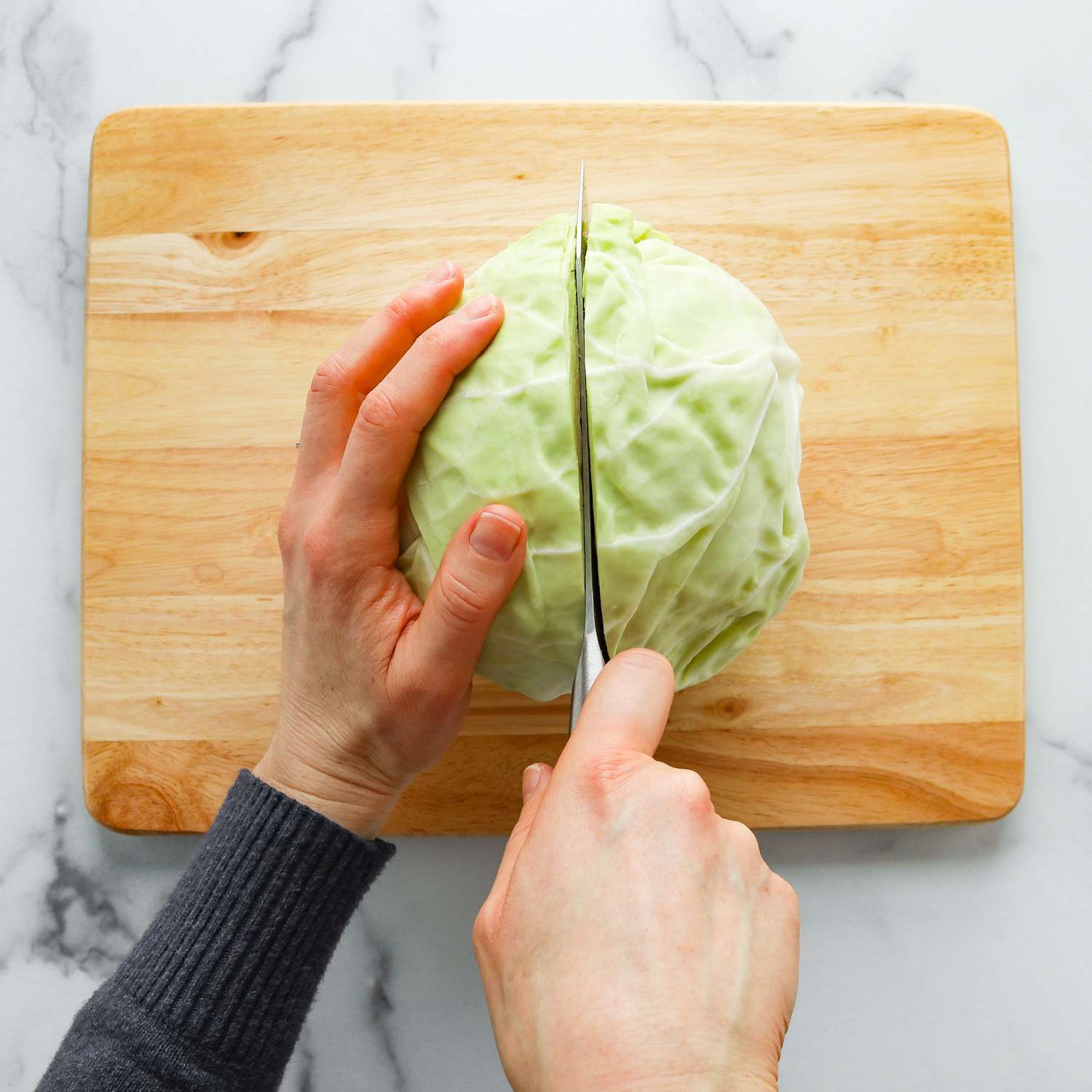 Close up of cutting a cabbage head in half
