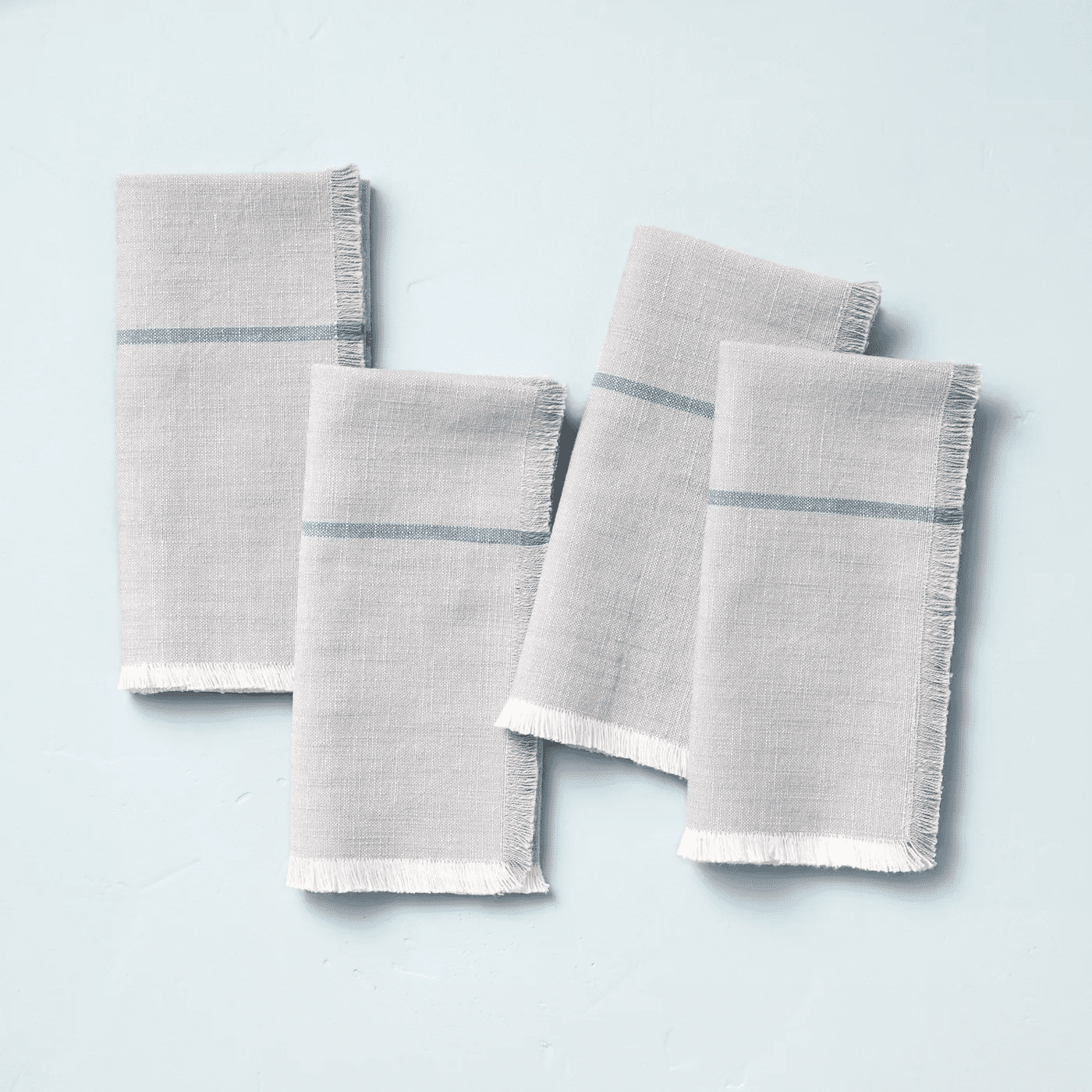 set of four grey napkins with blue stripes