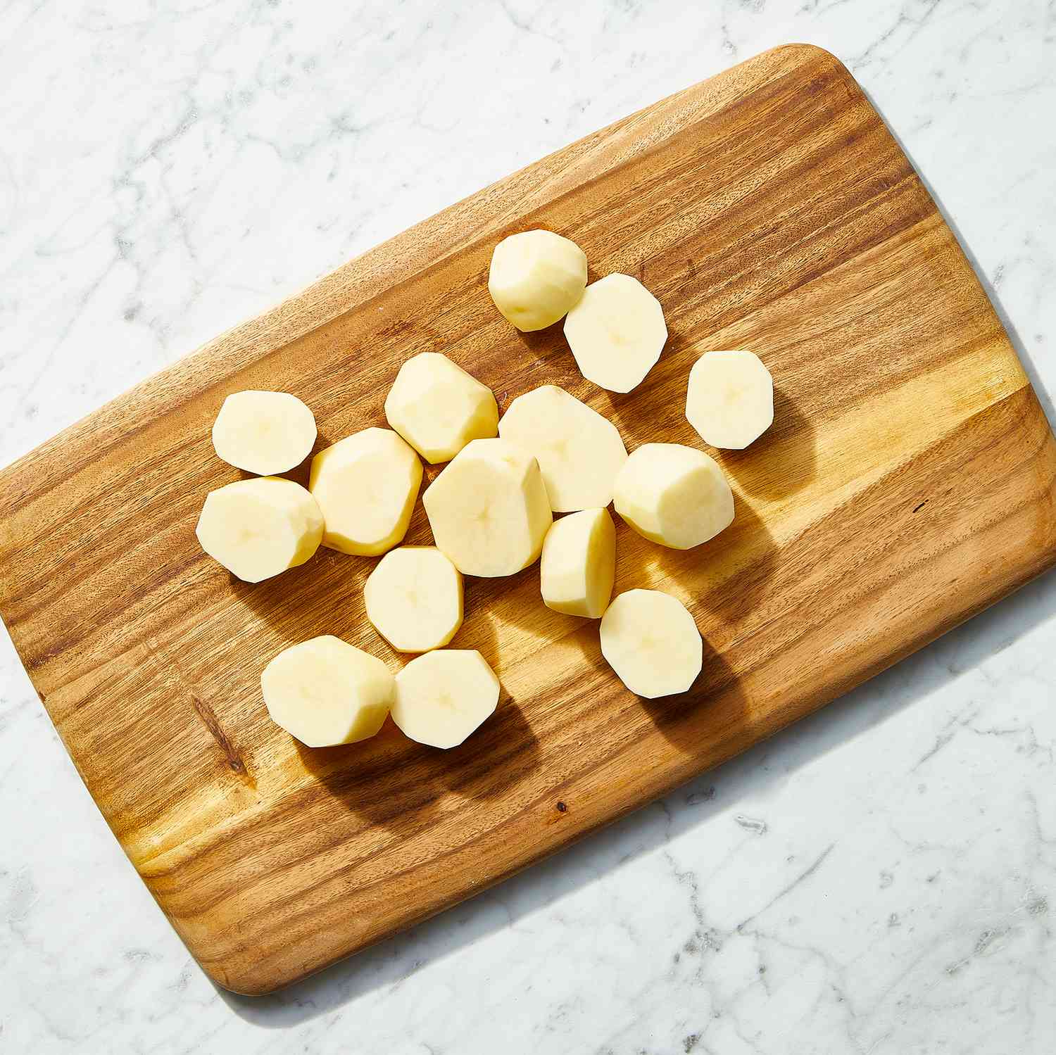 potato slices on a wood cutting board