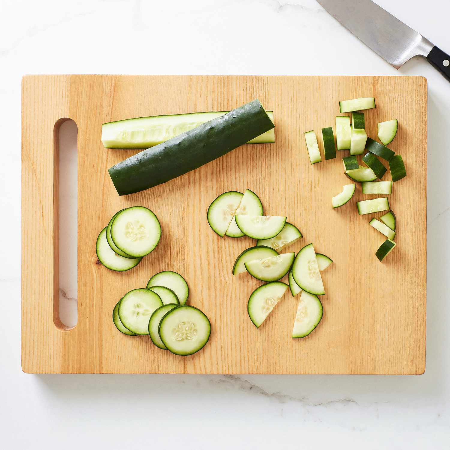 Close up of cut cucumbers on a cutting board