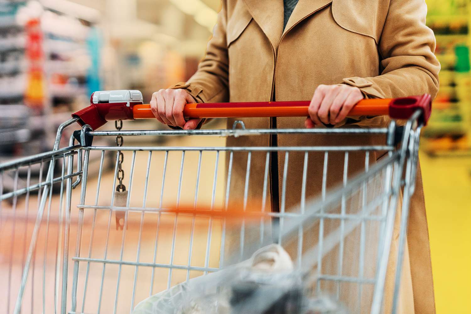 Cropped Shot Of Young Woman With Shopping Cart In Supermarket