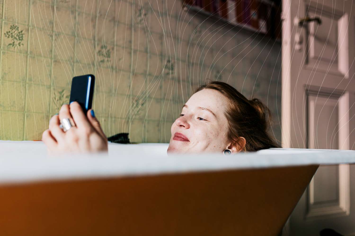 Woman Taking Bath And Smiling While Messaging Someone