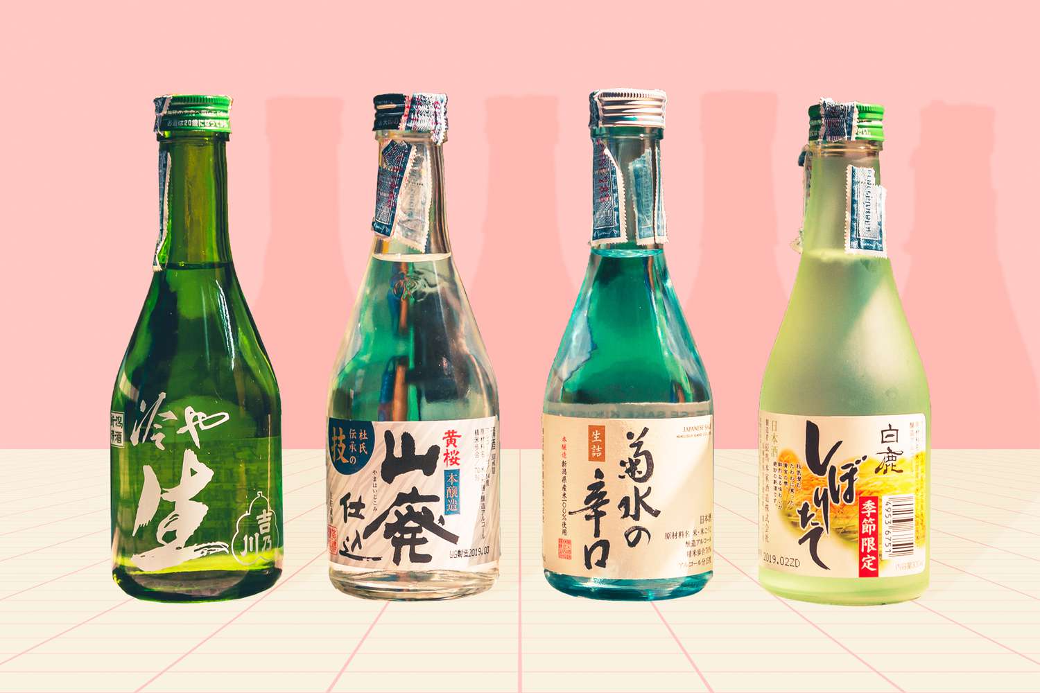 4 bottles of sake on a designed background