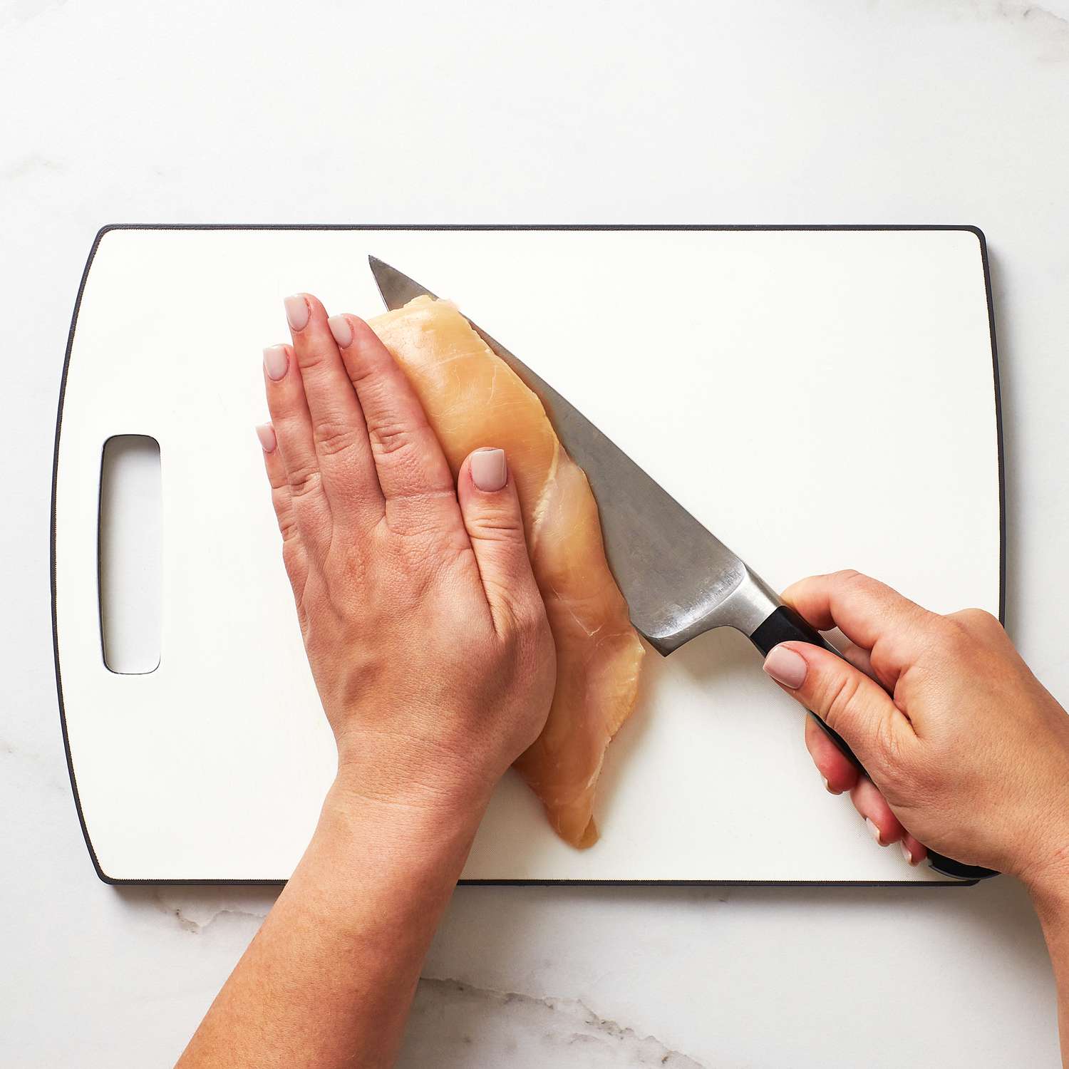 Close up of cutting a chicken breast