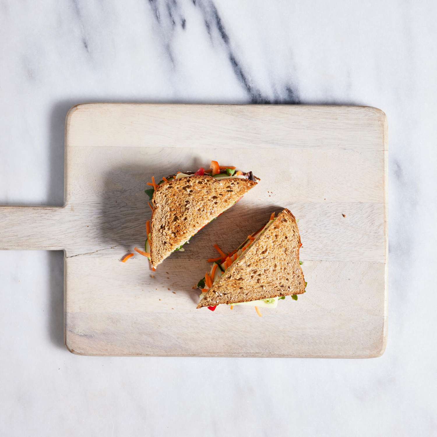 sliced vegetable sandwich on a board