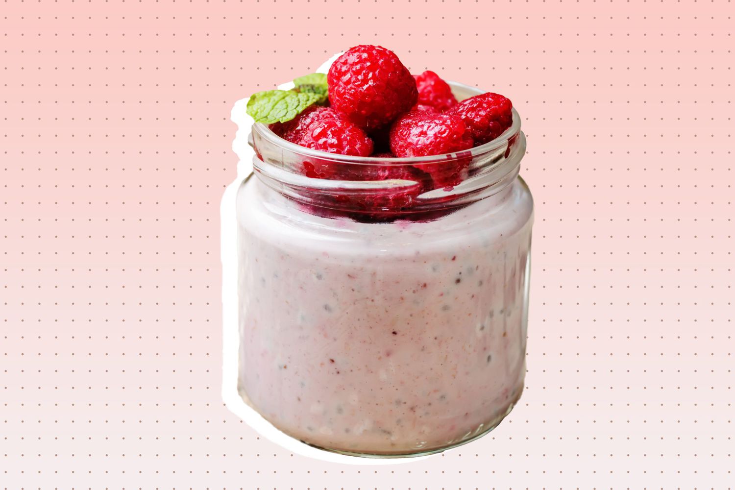 a jar of overnight oats and chia seeds with raspberries on top