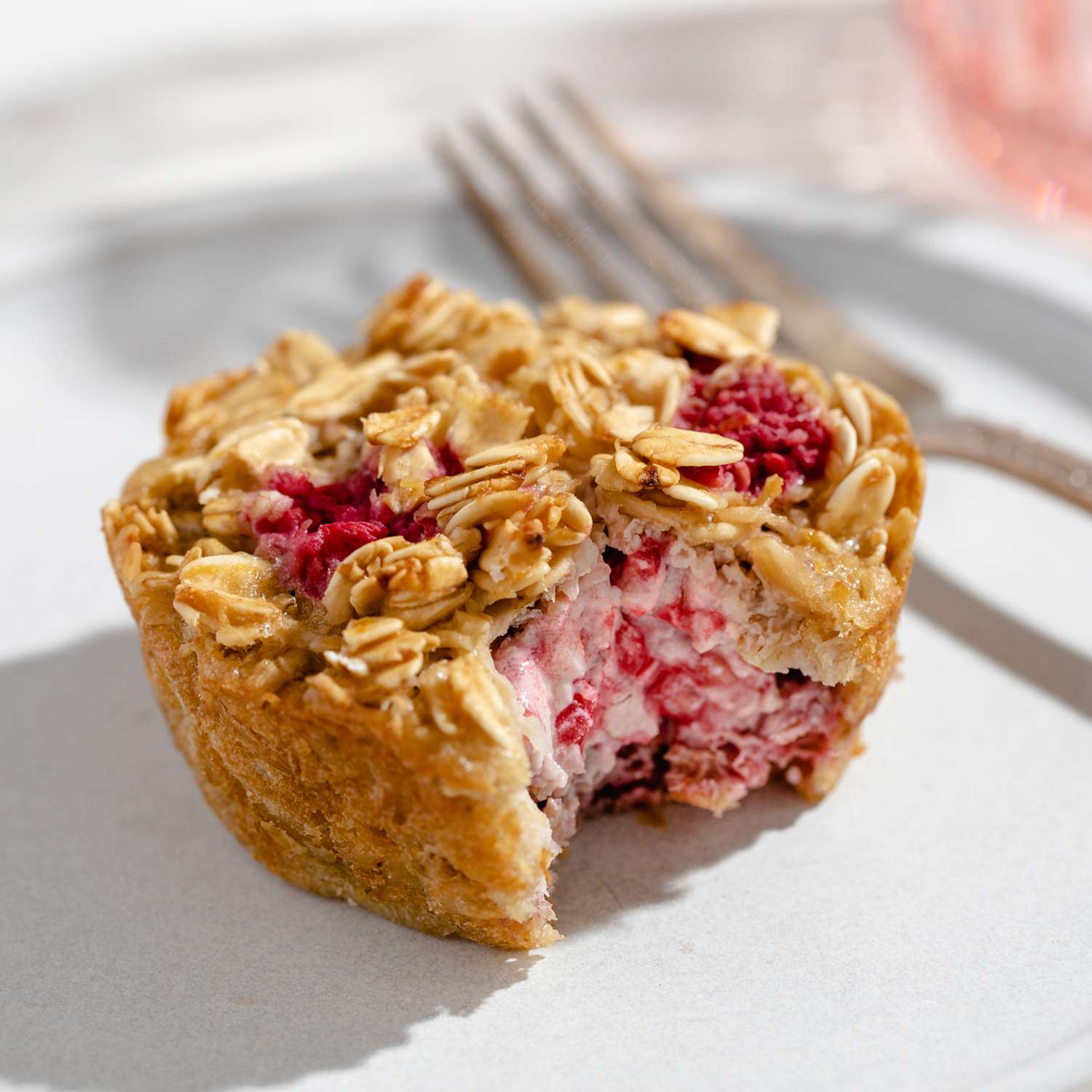 a recipe photo of the Lemon-Raspberry Cream Cheese Oatmeal Cakes served on a plate and cut open