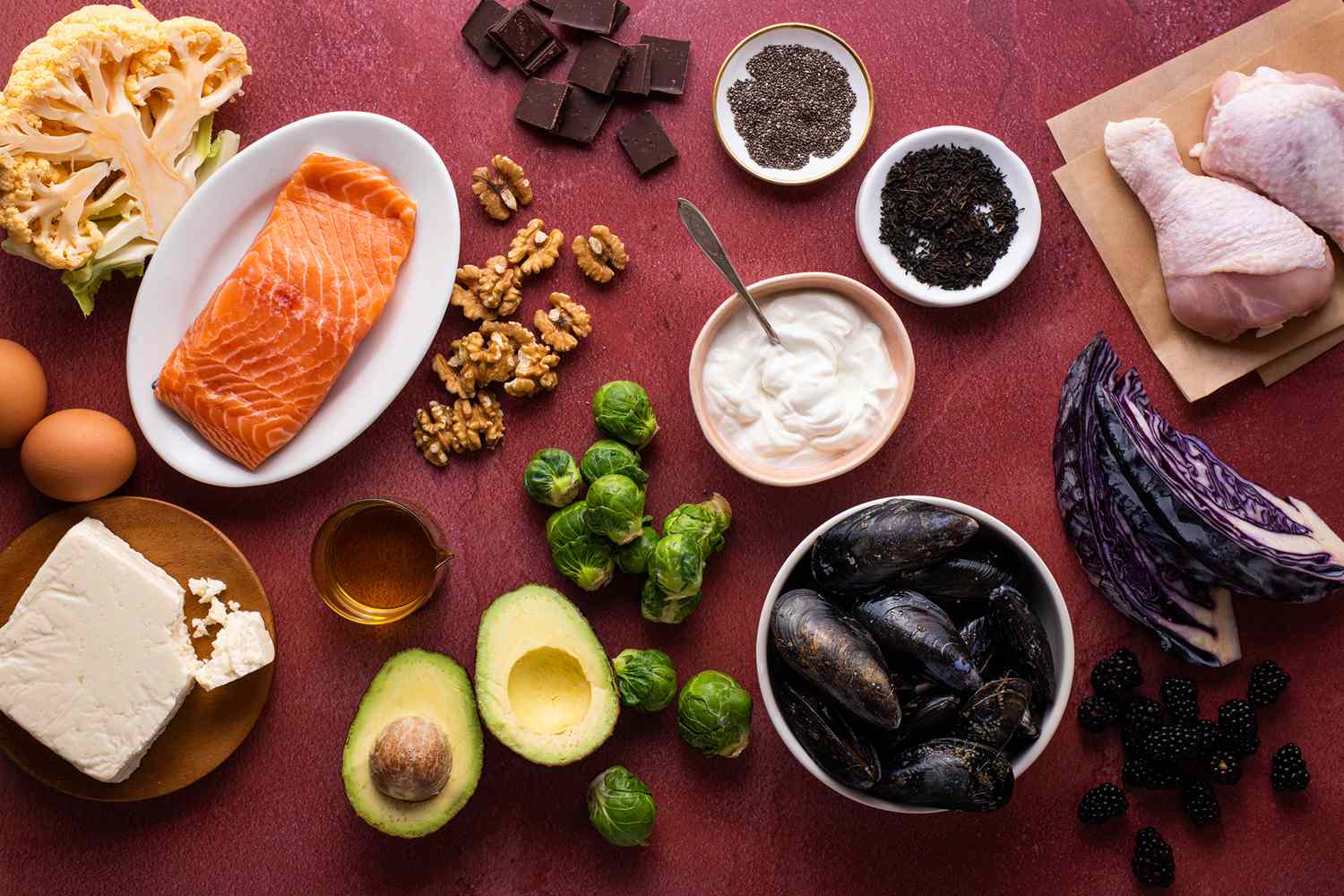 a still life of Keto friendly foods such as fish, vegetables, nuts, and more