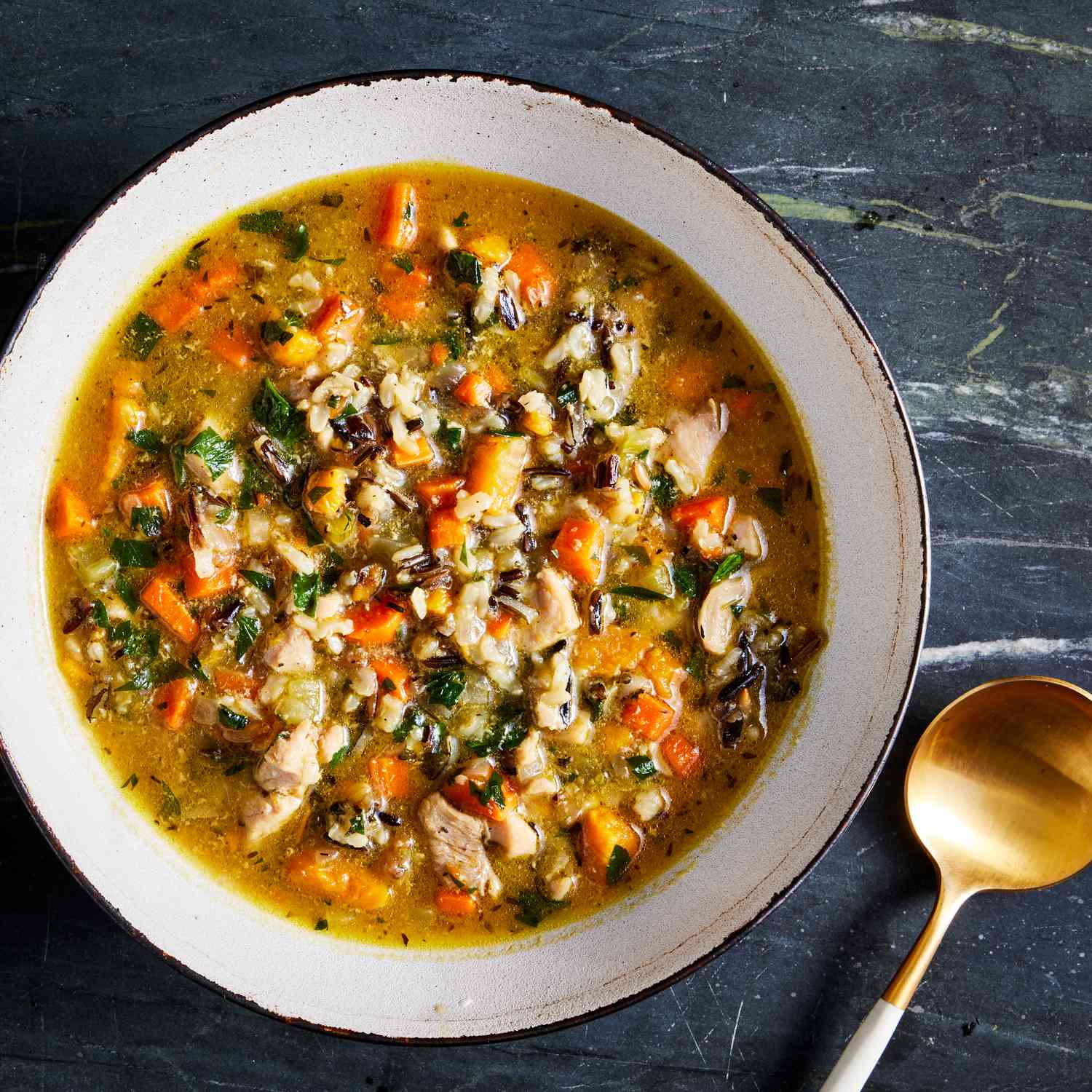 a recipe photo of the Chicken & Root Vegetable Soup with Wild Rice served in a bowl