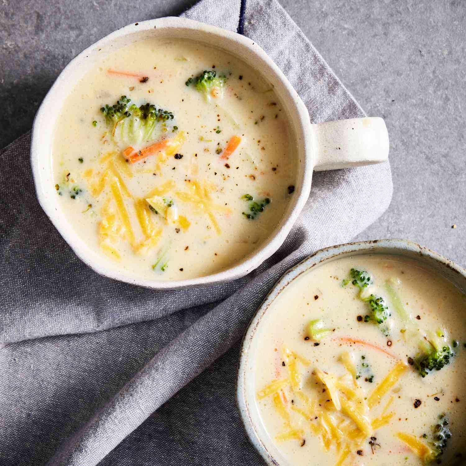 a recipe photo of the Copycat Panera's Broccoli-Cheddar Soup served in two bowls