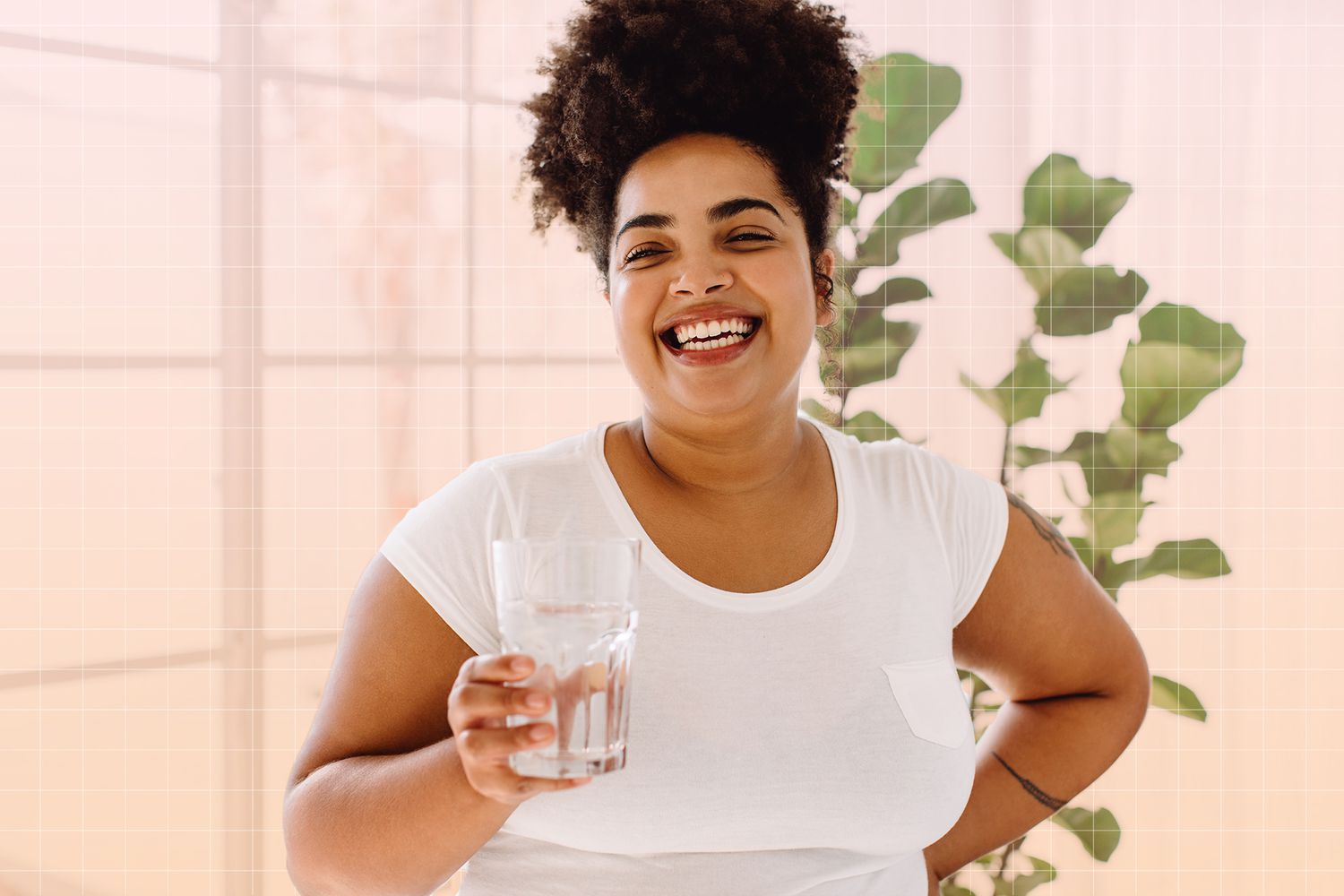 a woman smiling and having a glass of water