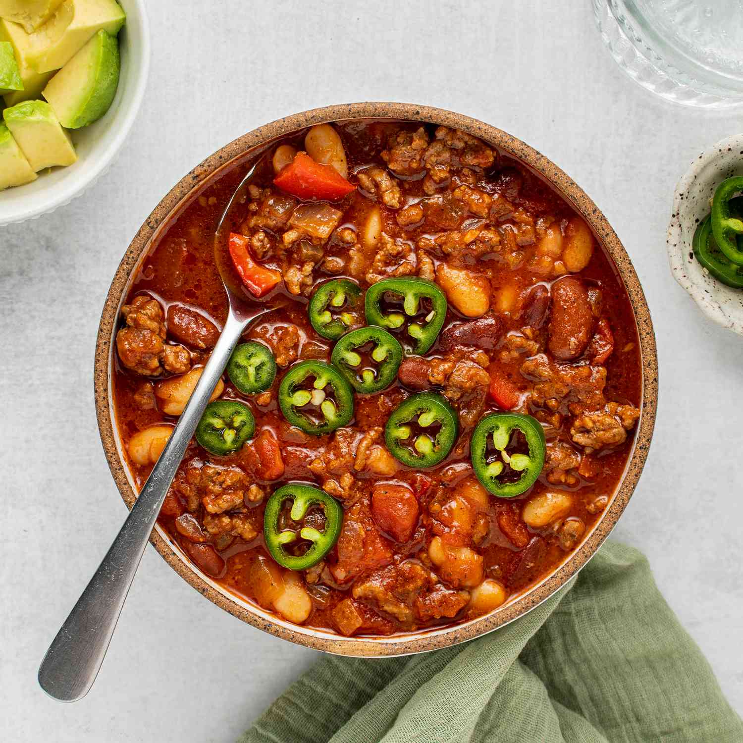 a recipe photo of the Kickin Hot Chili served in a bowl and topped with jalapenos