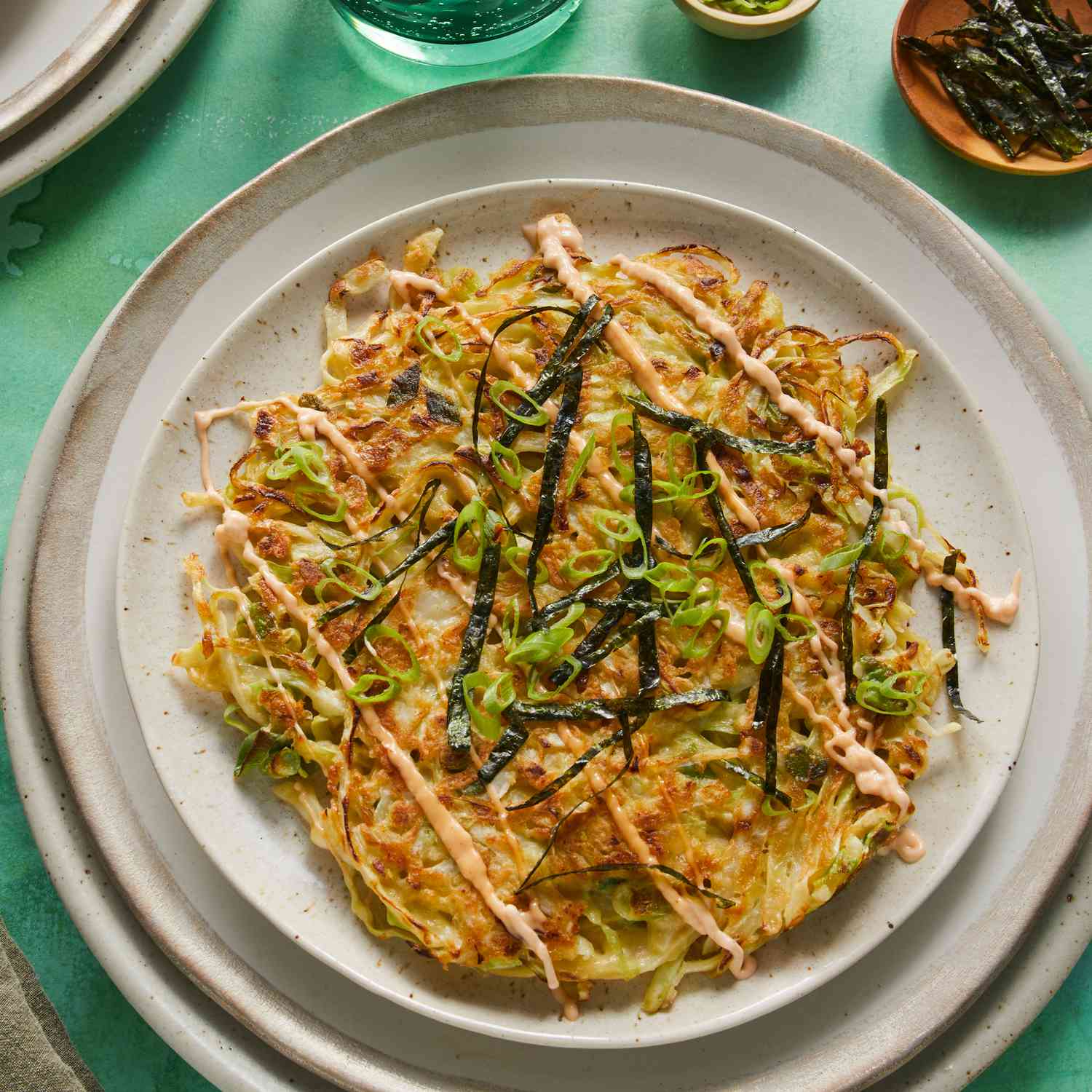 a recipe photo of the Okonomiyaki (Japanese Cabbage Pancake) served on a plate