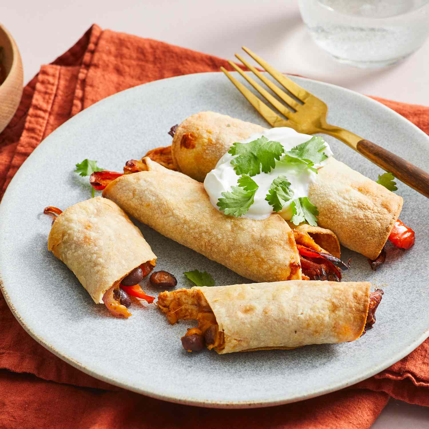 a recipe photo of the Air Fryer Chicken Taquitos served on a plate