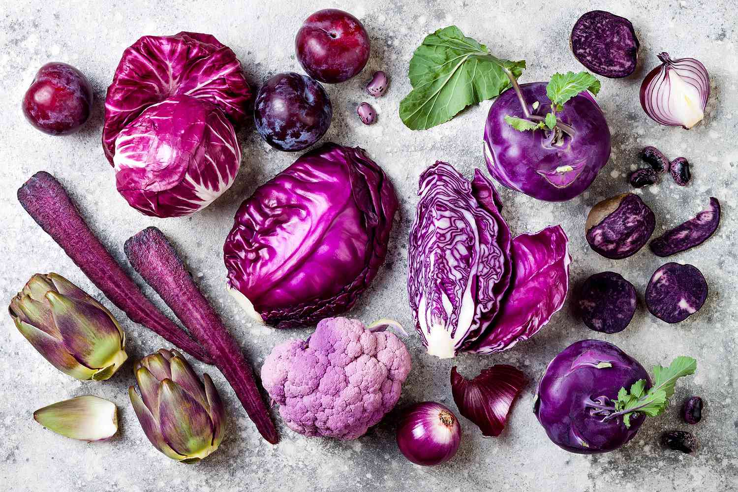 a photo of various purple fruits and vegetables