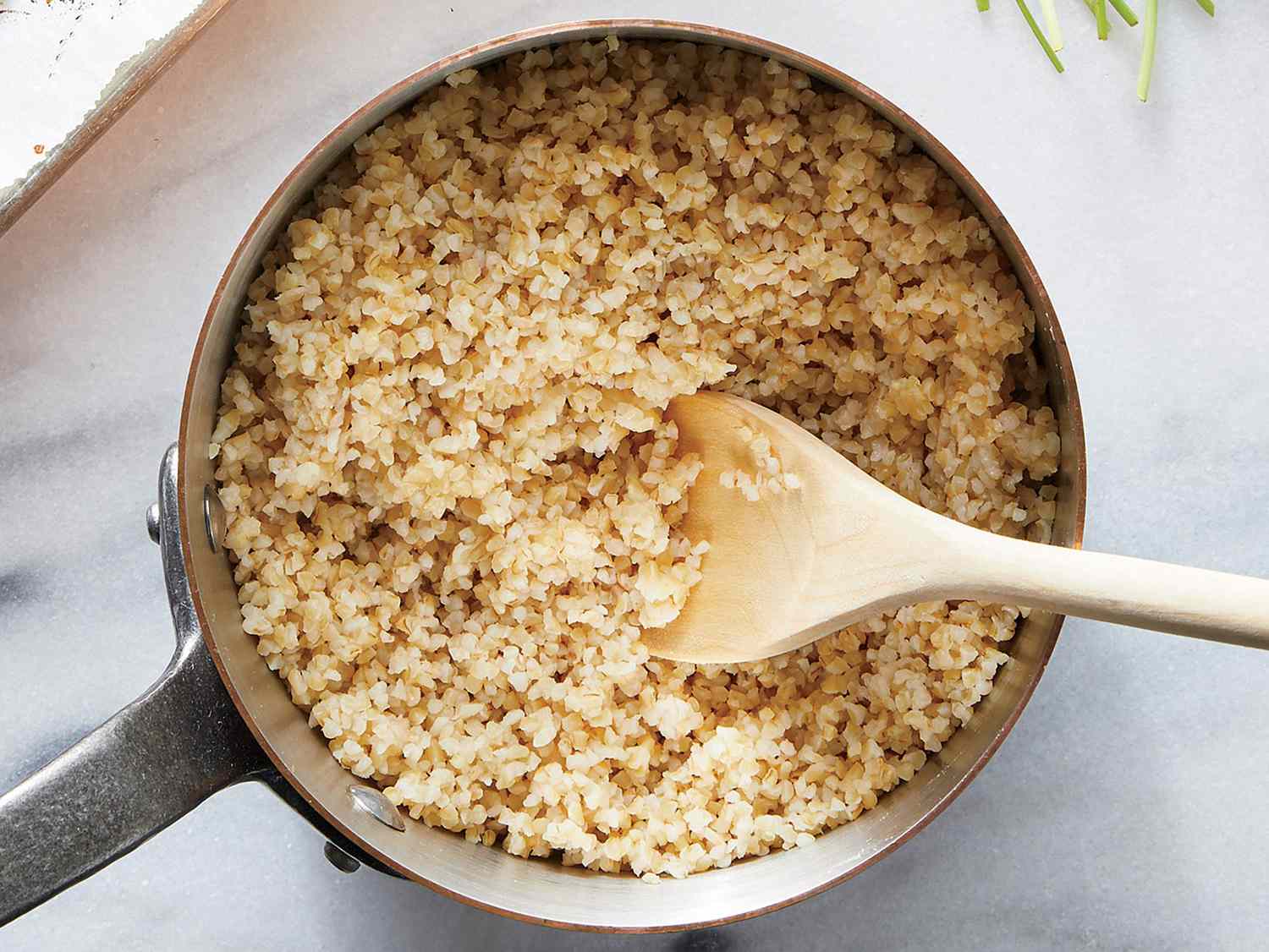 Basic Bulgur Recipe in a pot with a wooden spoon