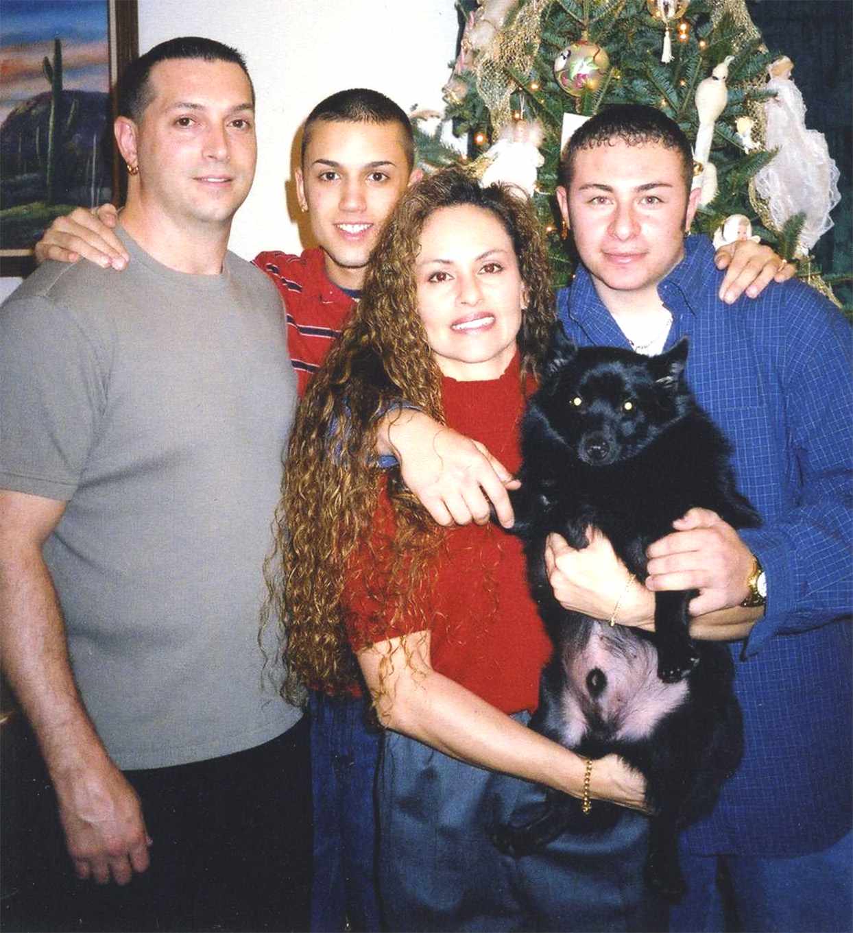 family Christmas photo with black dog