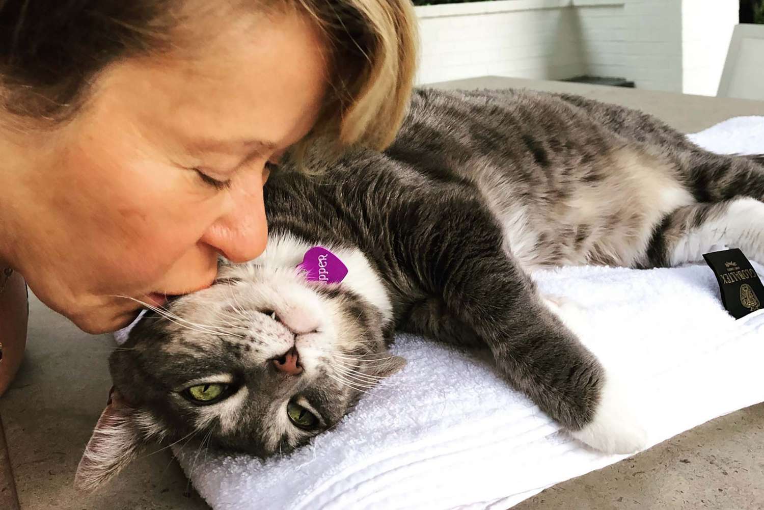 Voice actor Yeardley Smith kisses cat on face
