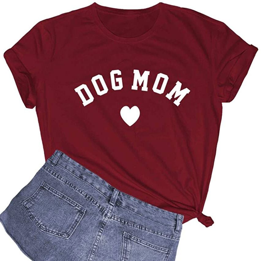 Product photo of a Dog Mom Shirt with a pair of denim shorts on a white background