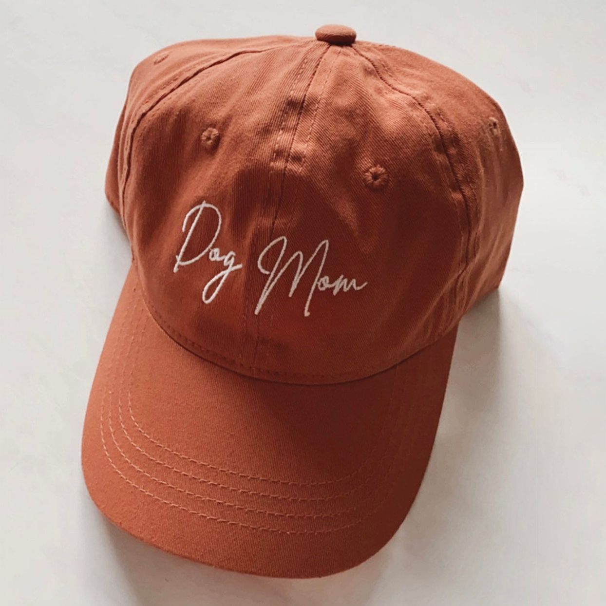 Product photo of a DOGMOM Minimalist Hat on an off-white background