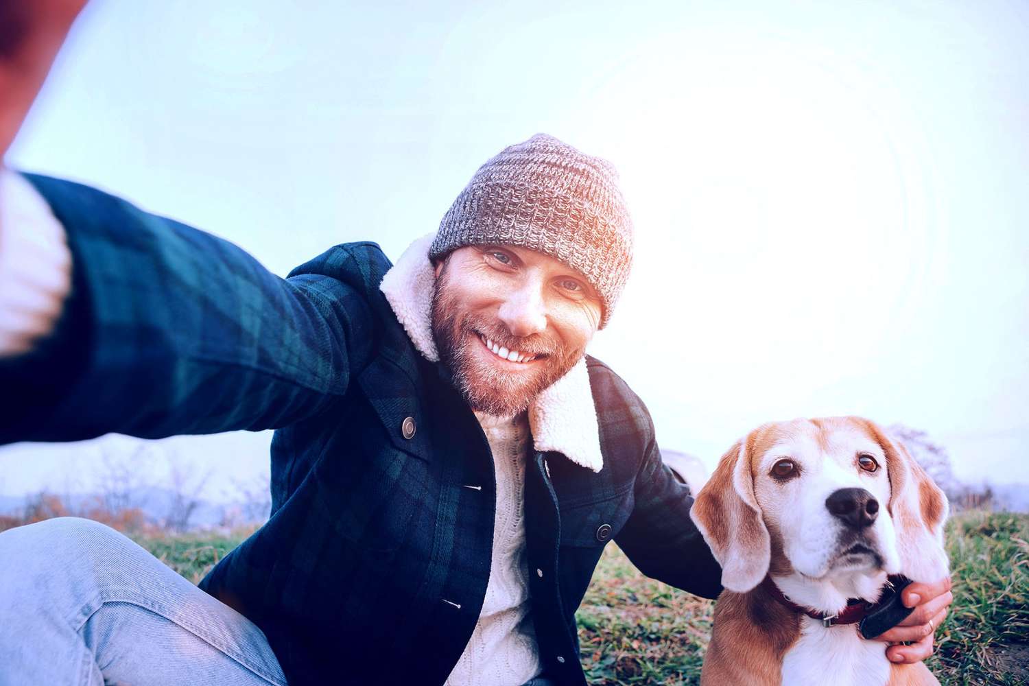 man taking a selfie outdoors with his dog