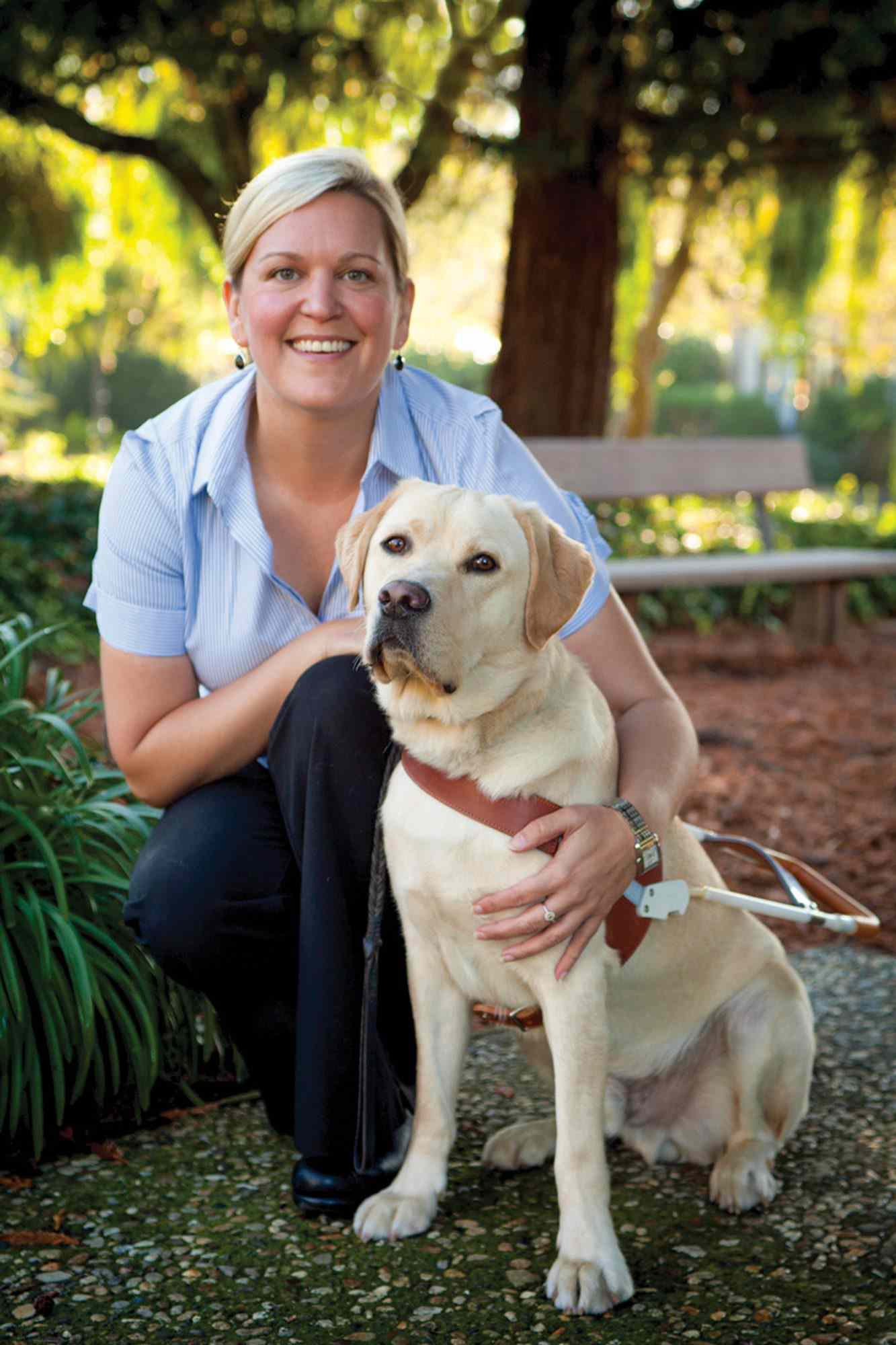 Susan Armstrong with a Golden Lab guide dog