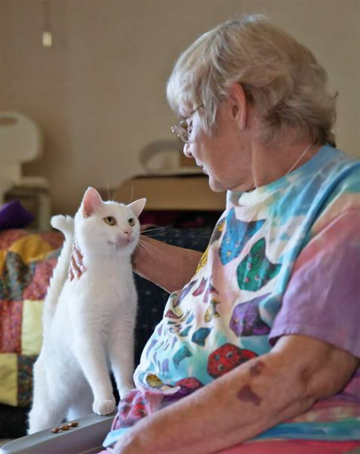 Woman sitting with her white cat