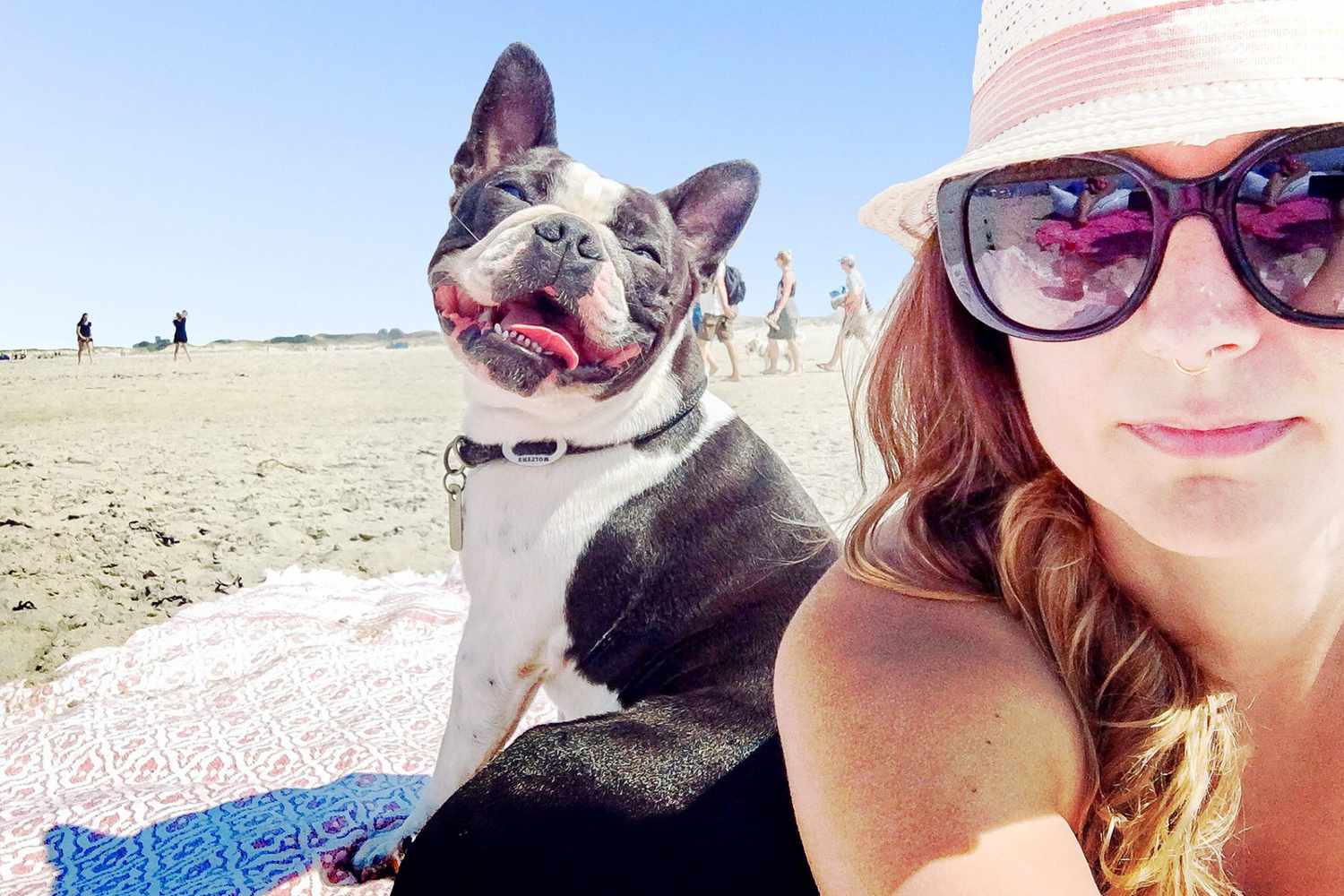 woman and french bulldog on spring break at the beach