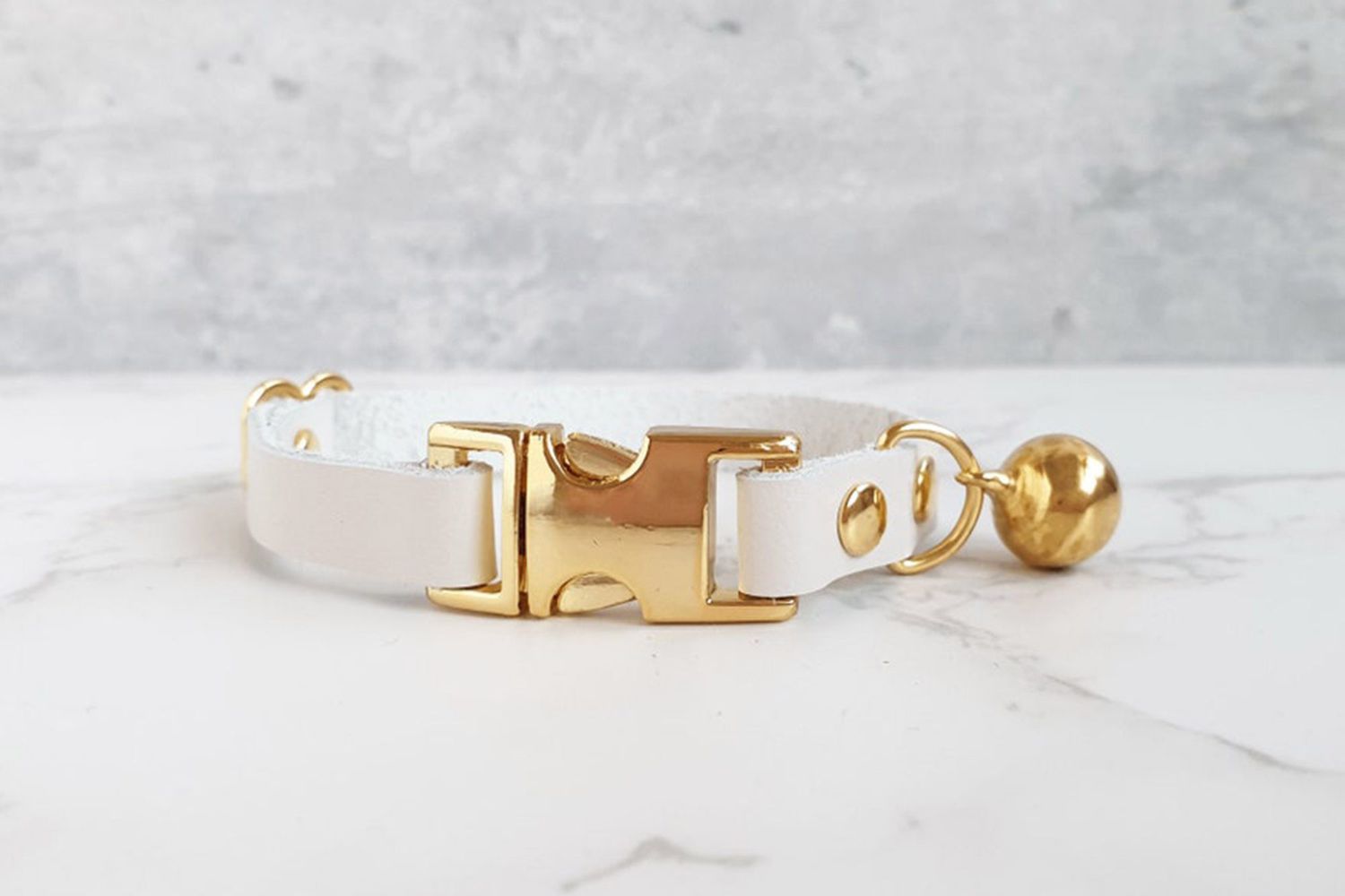 white leather kitten color with gold accents and bell