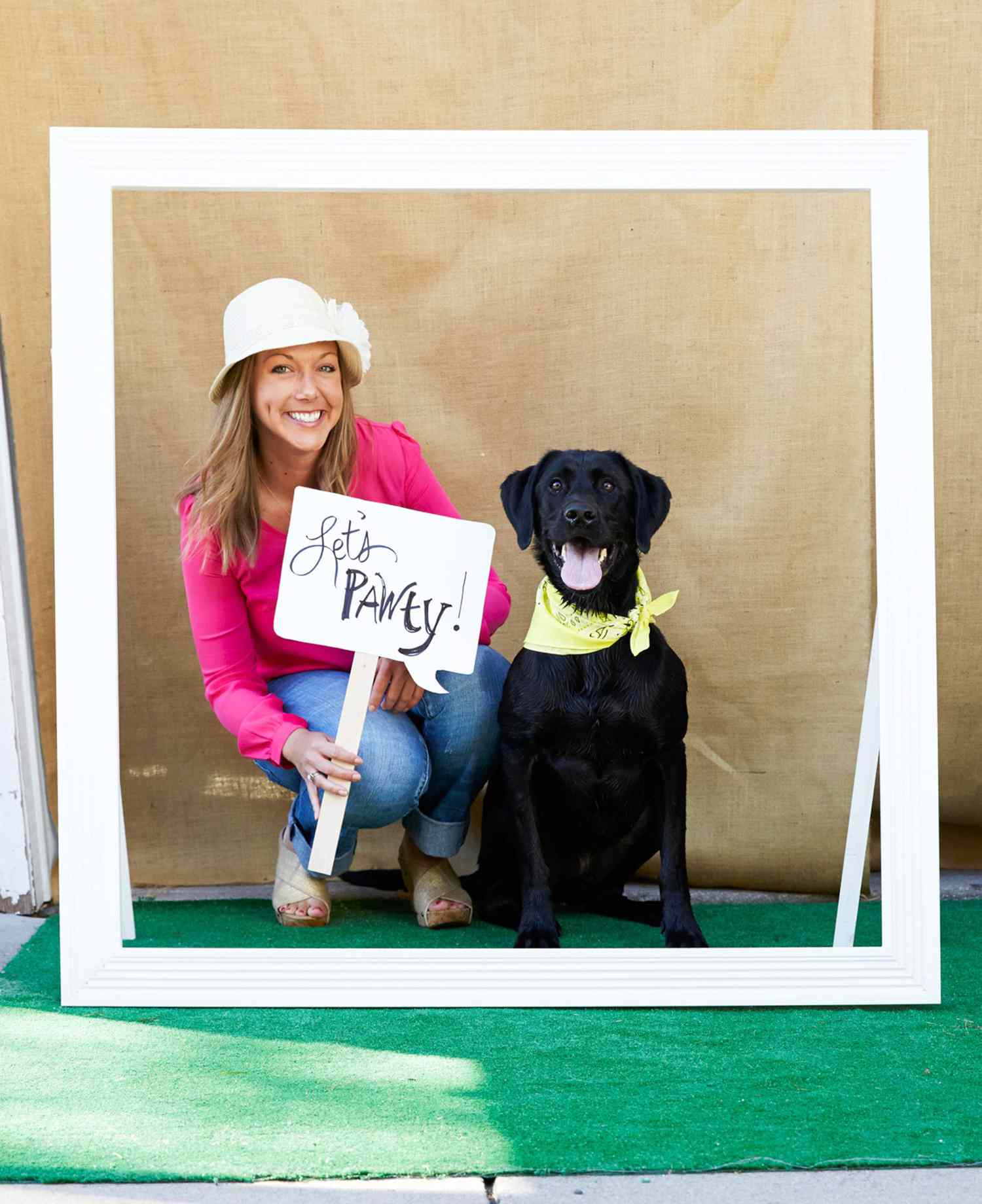 woman posing with her dog in a photo booth