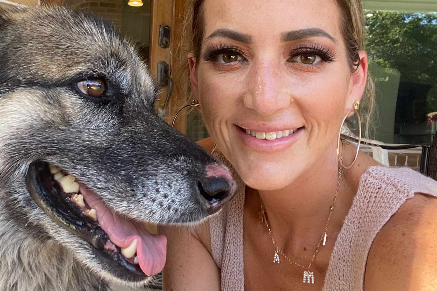 woman with dog that was returned home after 4 years