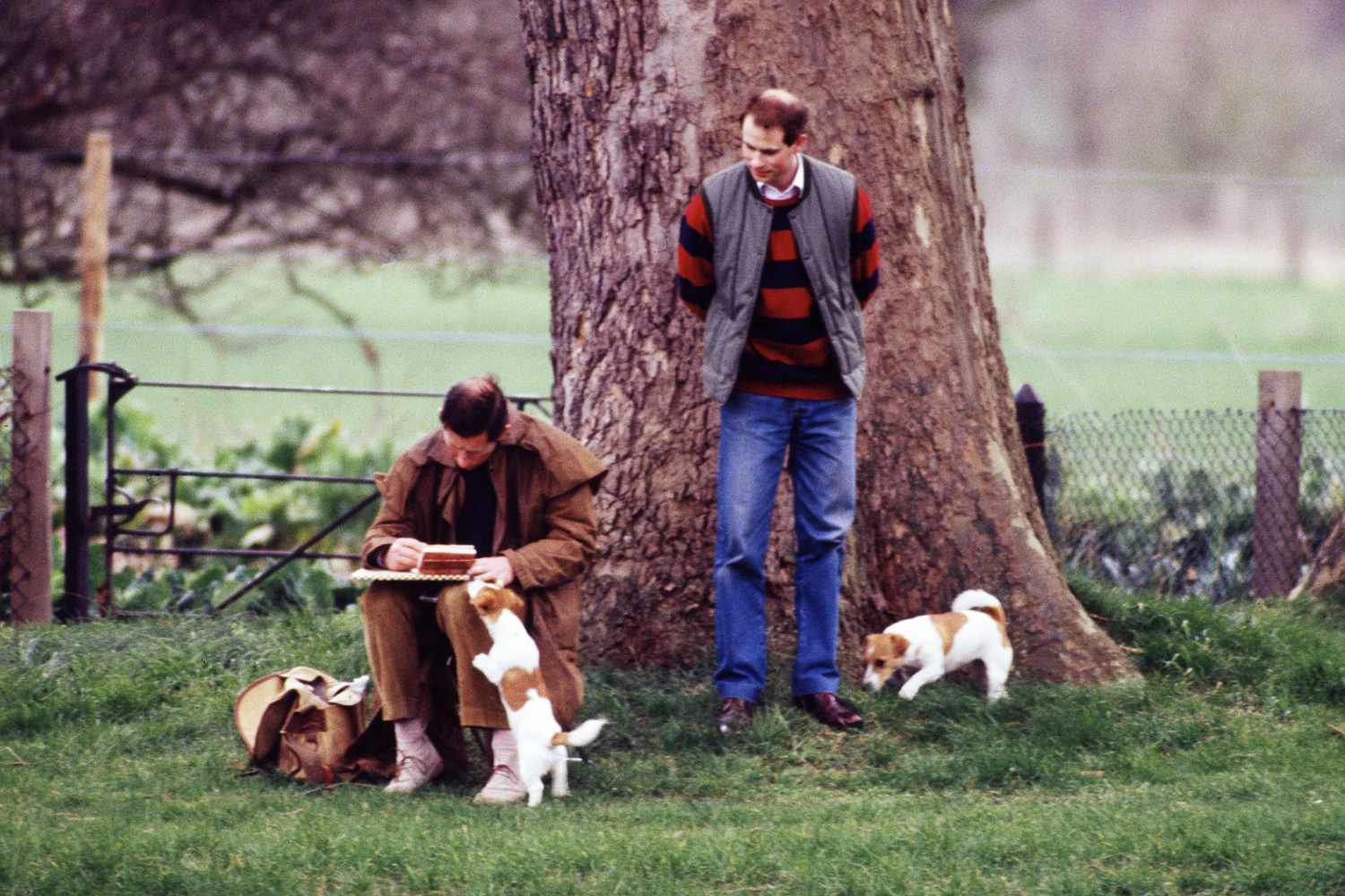 Prince Charles sketching on the bank of the River Thames, at Windsor Castle, with Prince Edward, and accompanied by his dogs in 1989