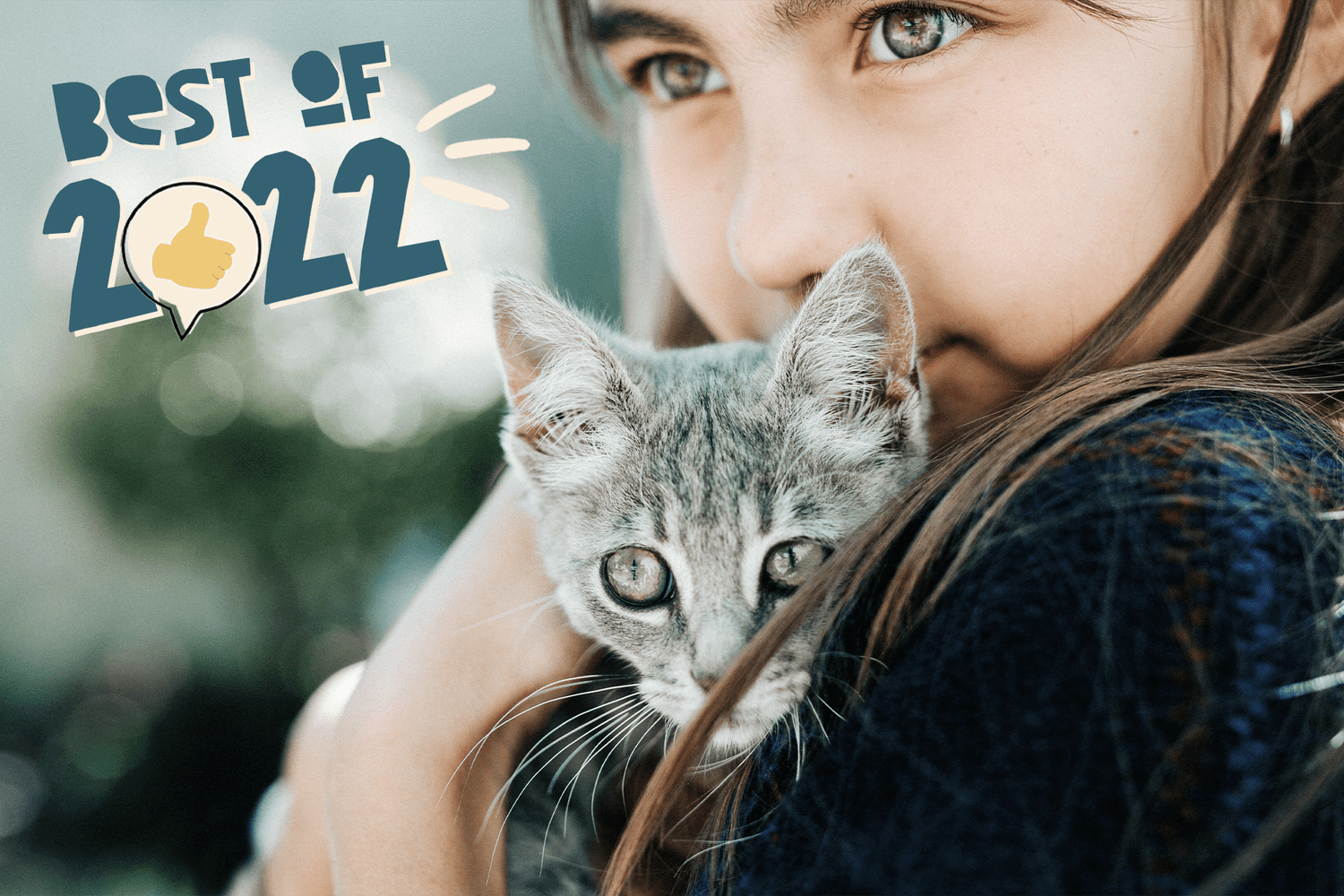 girl holding kitten; best cat names of 2022