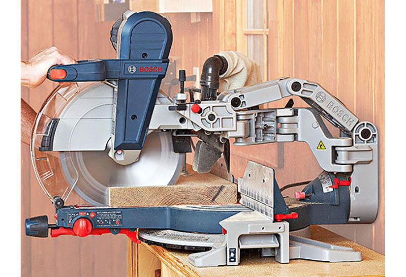 Hands on a mitersaw with faded background