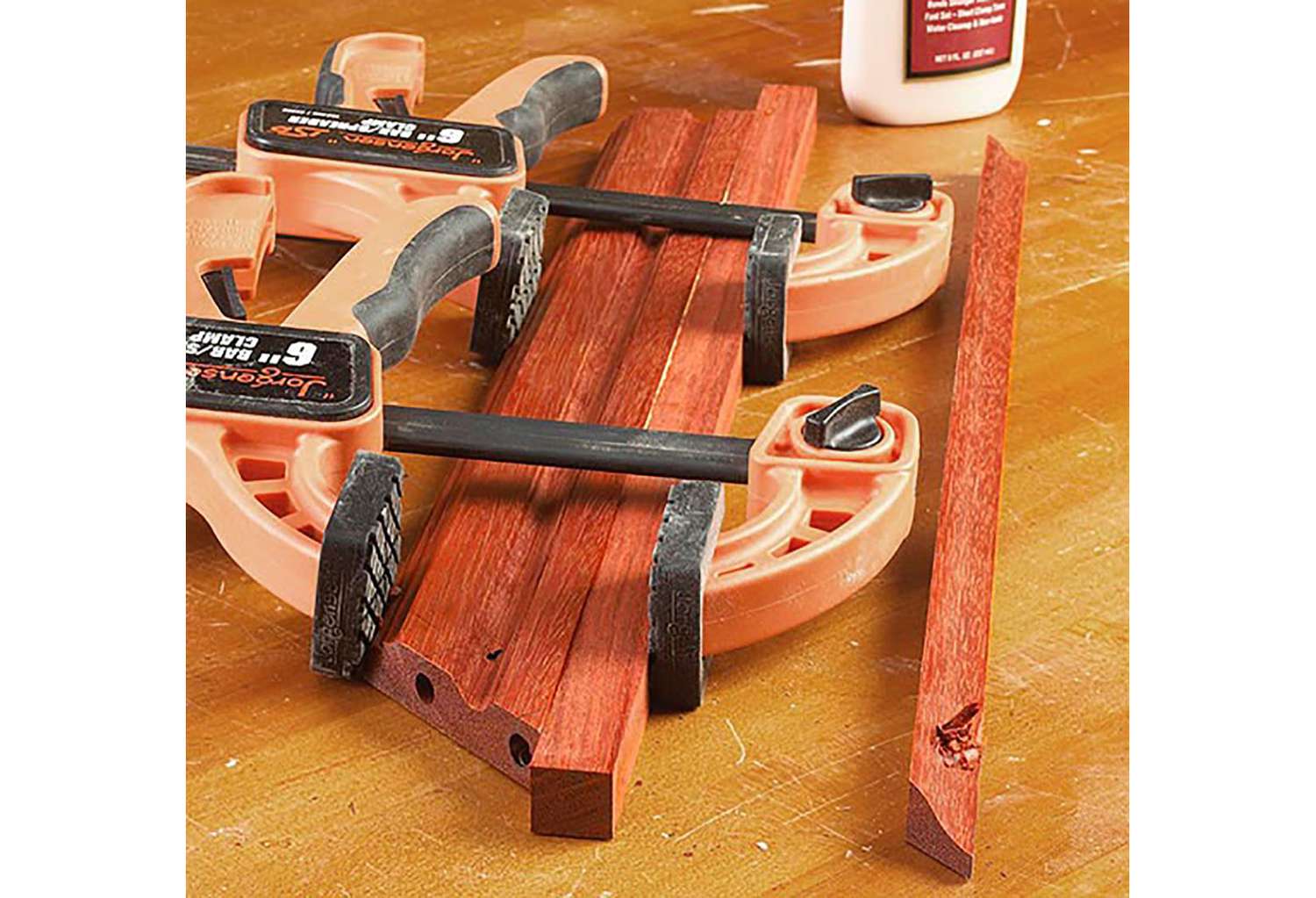 Orange clamp with 3 boards