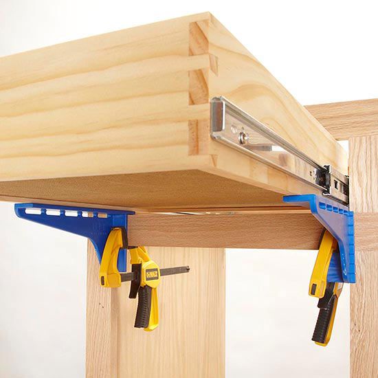 Clamps under drawer