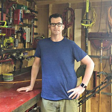 Chris Smith standing in his shop.