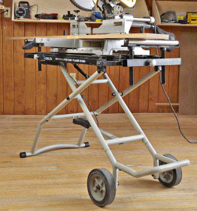 Miter saw on top of a folding metal stand.