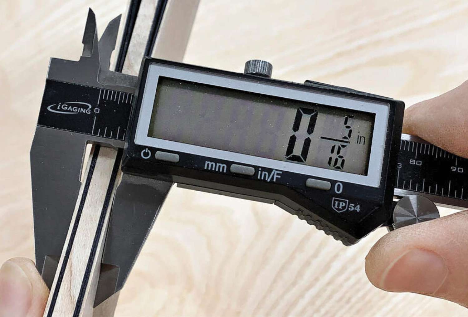 Photo of caliper measuring packet width.