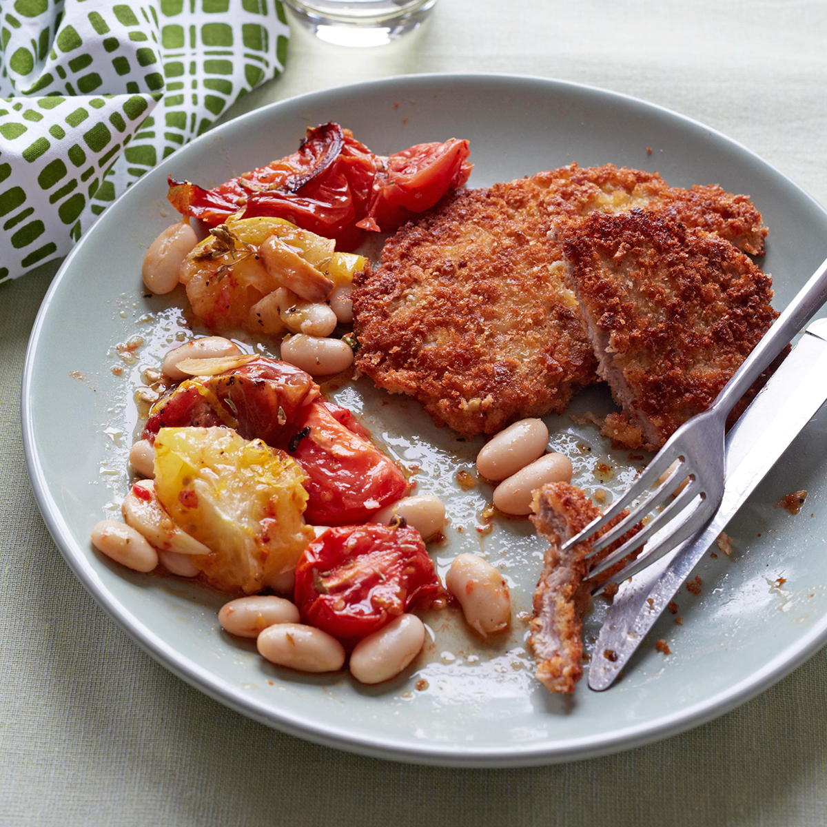 breaded pork cutlets with roasted tomatoes and white beans