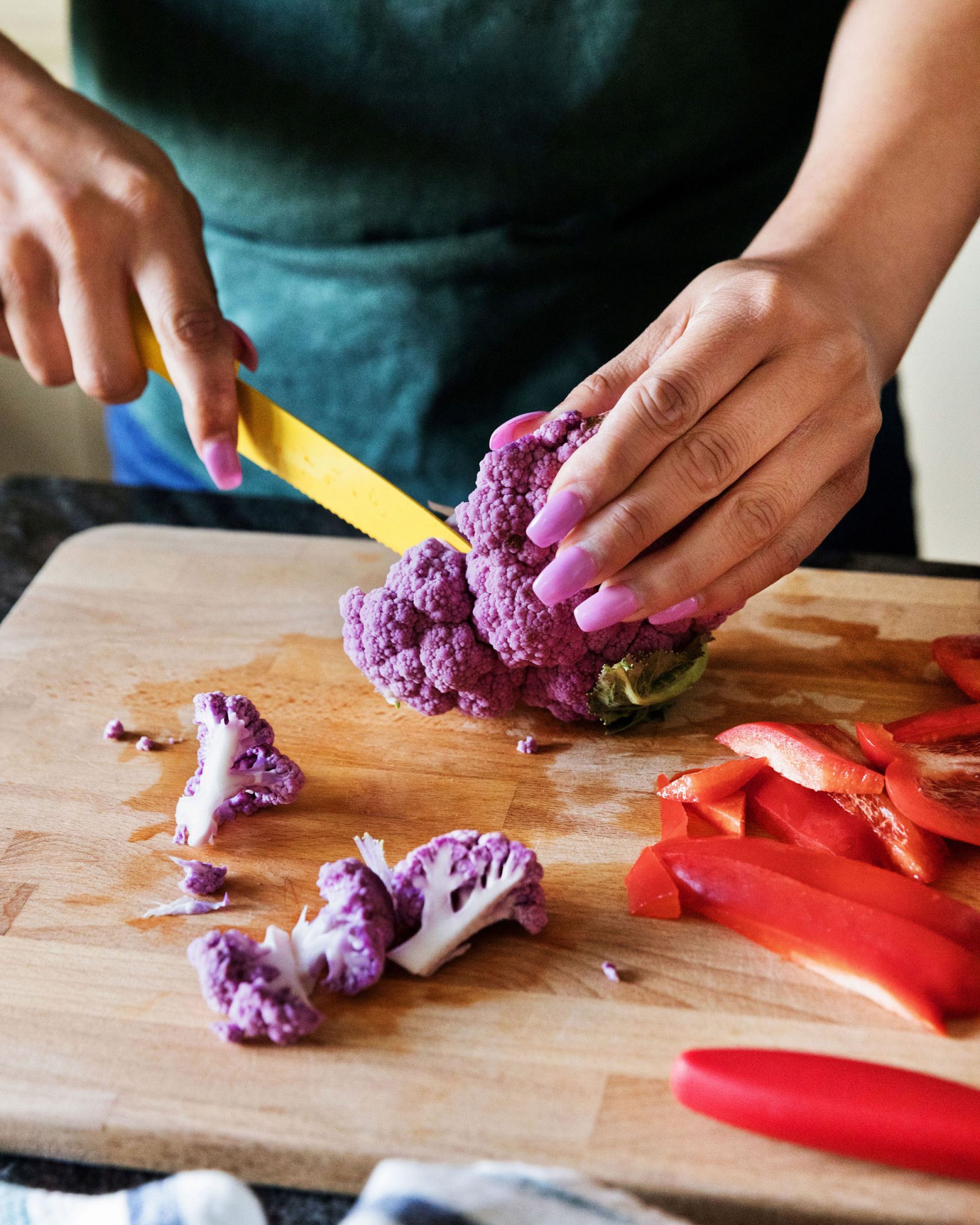 chopping purple cauliflower and red pepper